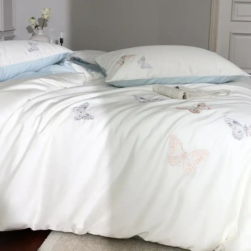 White satin lyocell cotton bedding set with decorbites butterfly embroidery in pastel pink and silver shades