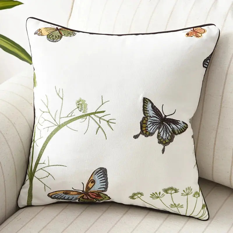 White cotton pillow cover with embroidered butterfly floral design in brown gray orange and olive for bedroom decor