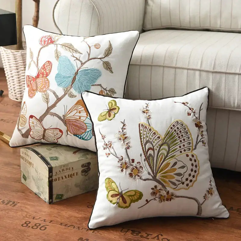 White cotton pillow cover with embroidered butterfly floral design in blue orange green and brown for bedroom decor