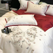 Cream-colored satin bedding set with intricate butterfly flowers embroidery and subtle red piping by decorbites butterfly flowers