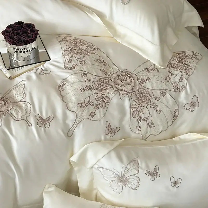 Cream satin bedding set with intricate silver-toned butterfly flowers embroidery by decorbites for elegant bedroom decor