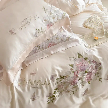 Cream-colored satin bedding set with butterfly flowers embroidery in soft pink and silver for elegant bedroom decorbites decor