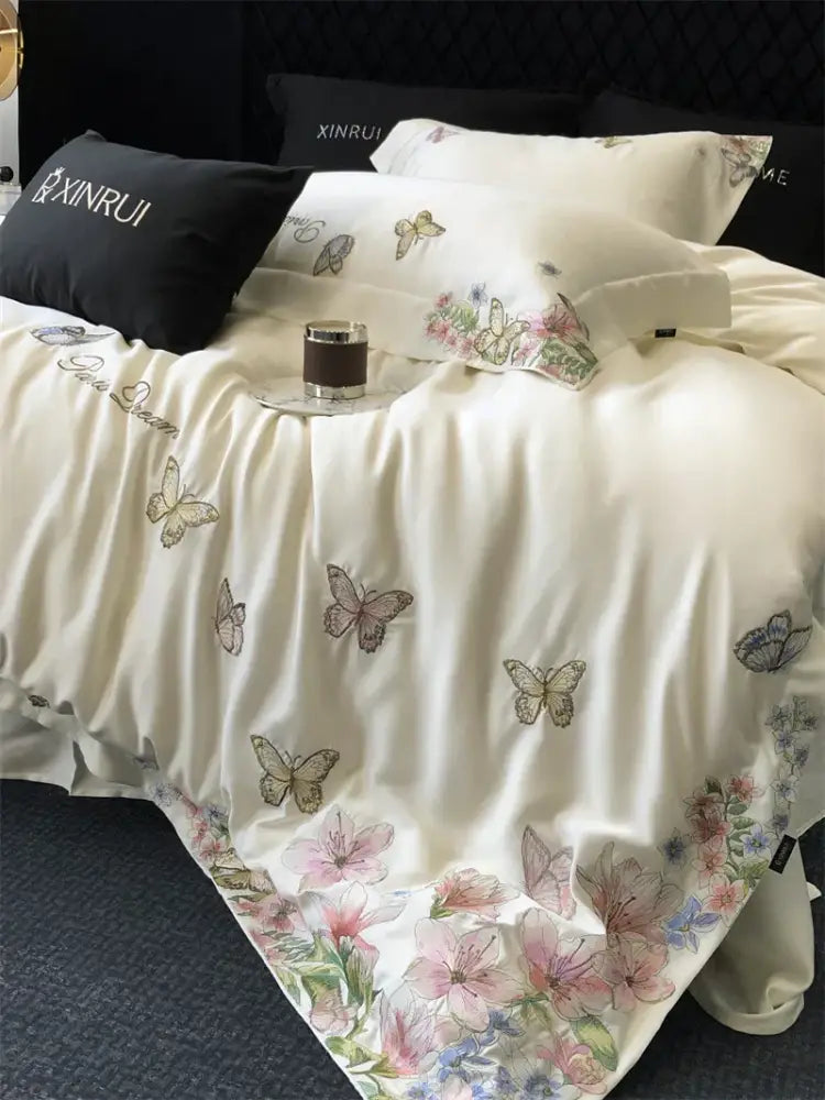 Cream satin bedding set with decorbites butterfly flowers embroidery featuring delicate pastel floral designs