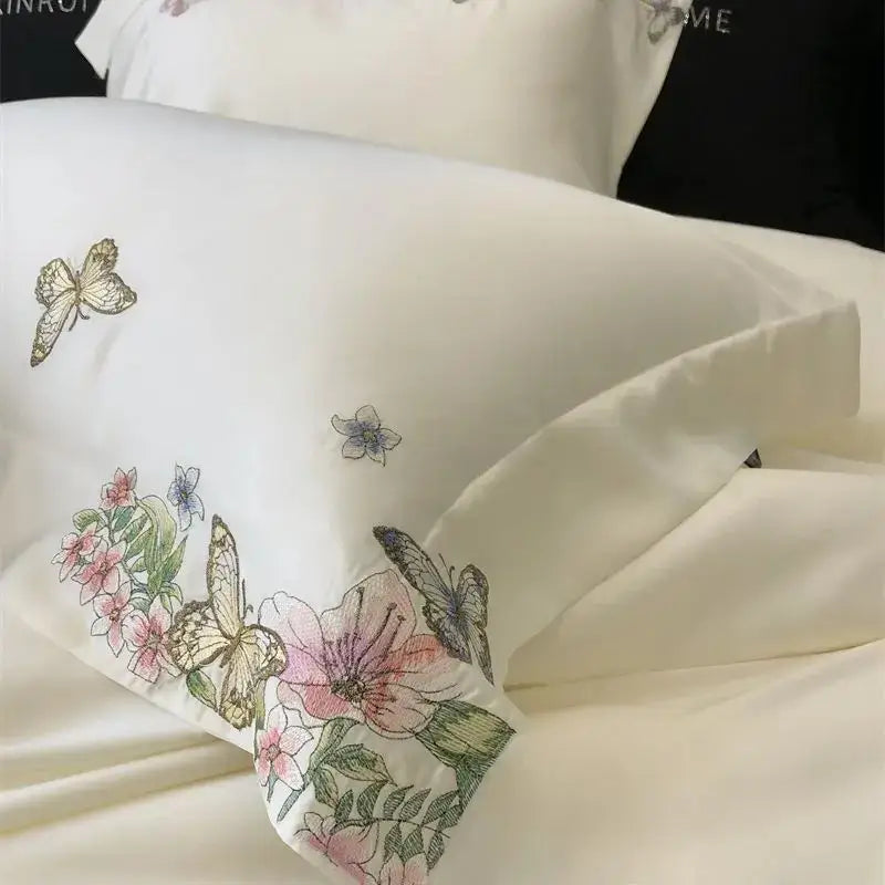 Cream satin pillowcase with butterfly flowers embroidery and pink floral decorbites butterfly flowers bedding set detail