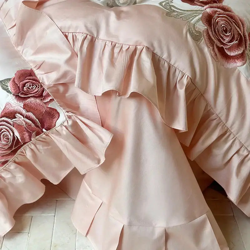 Pink satin bedding set featuring butterfly flowers embroidery with layered ruffles and rose accents for decorbites decor