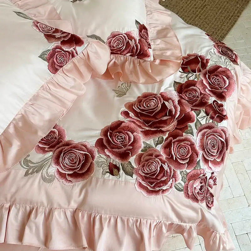 Pink satin bedding set with butterfly flowers embroidery featuring burgundy rose details and delicate ruffled edges