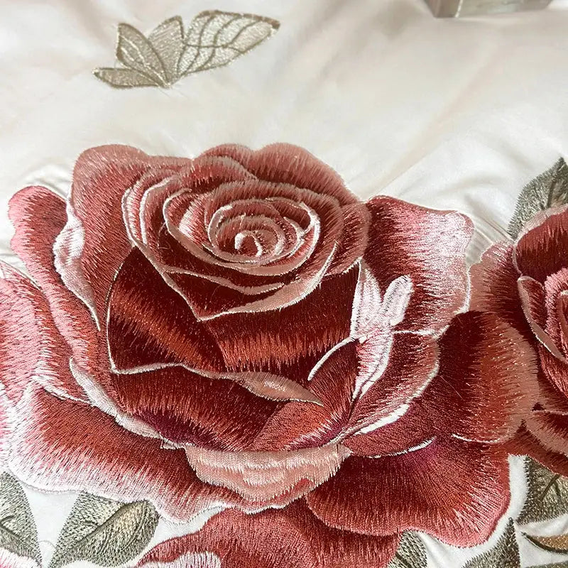 Butterfly flowers embroidery on pink satin bedding set features richly embroidered deep red rose with metallic thread accents