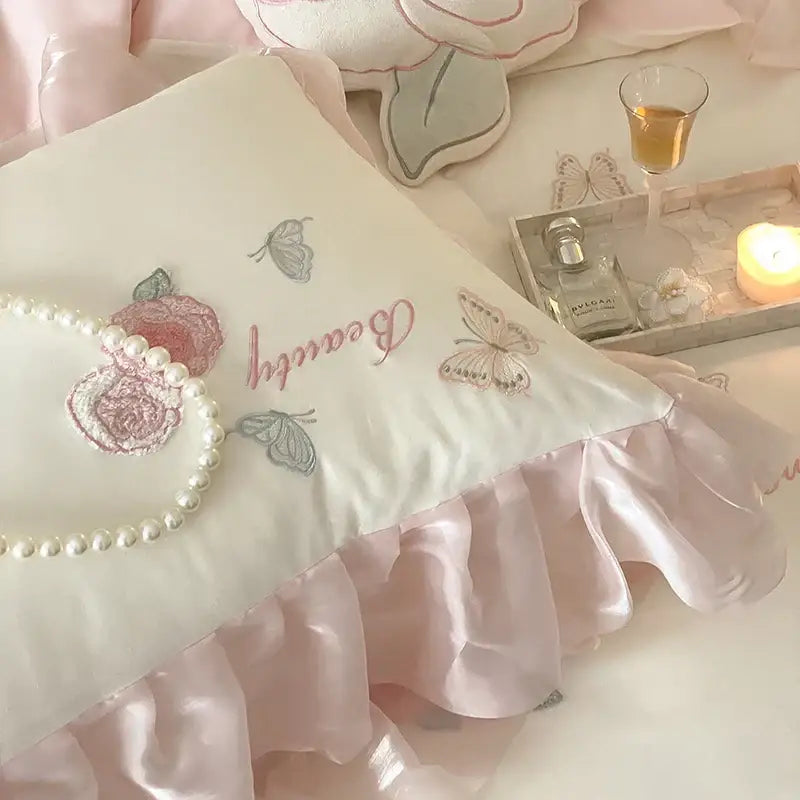 A soft ivory pillow from the decorbites butterfly flowers lace bedding set with pink silver embroidery and satin ruffle