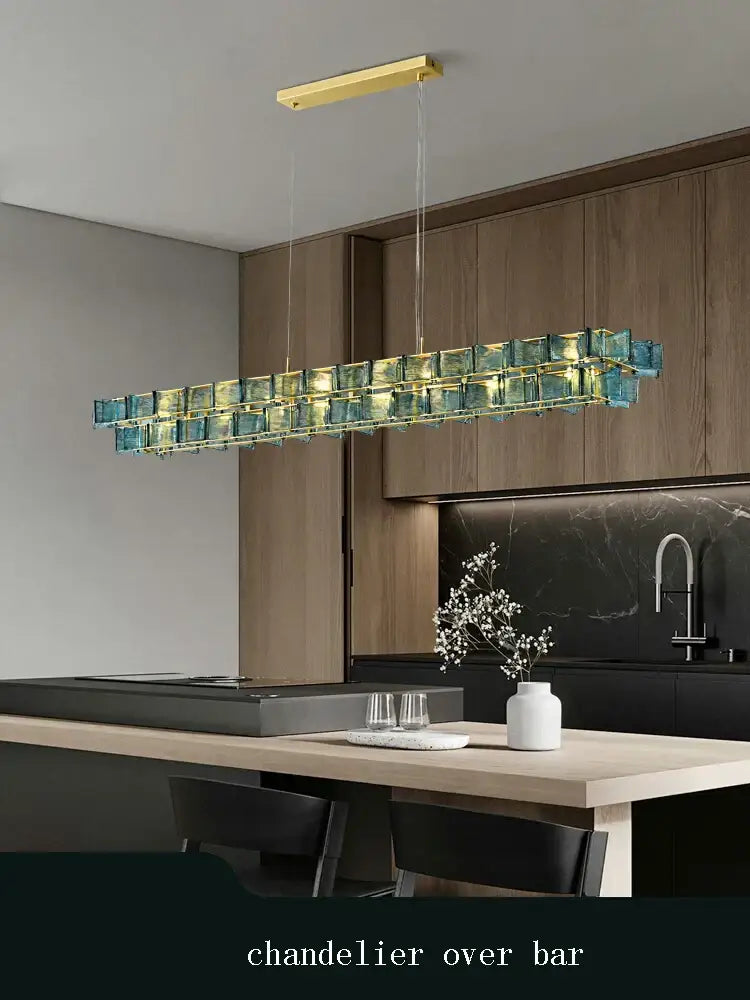 A decorbites butterfly glass chandelier with layered turquoise glass cubes and gold metal frame for dining room decor