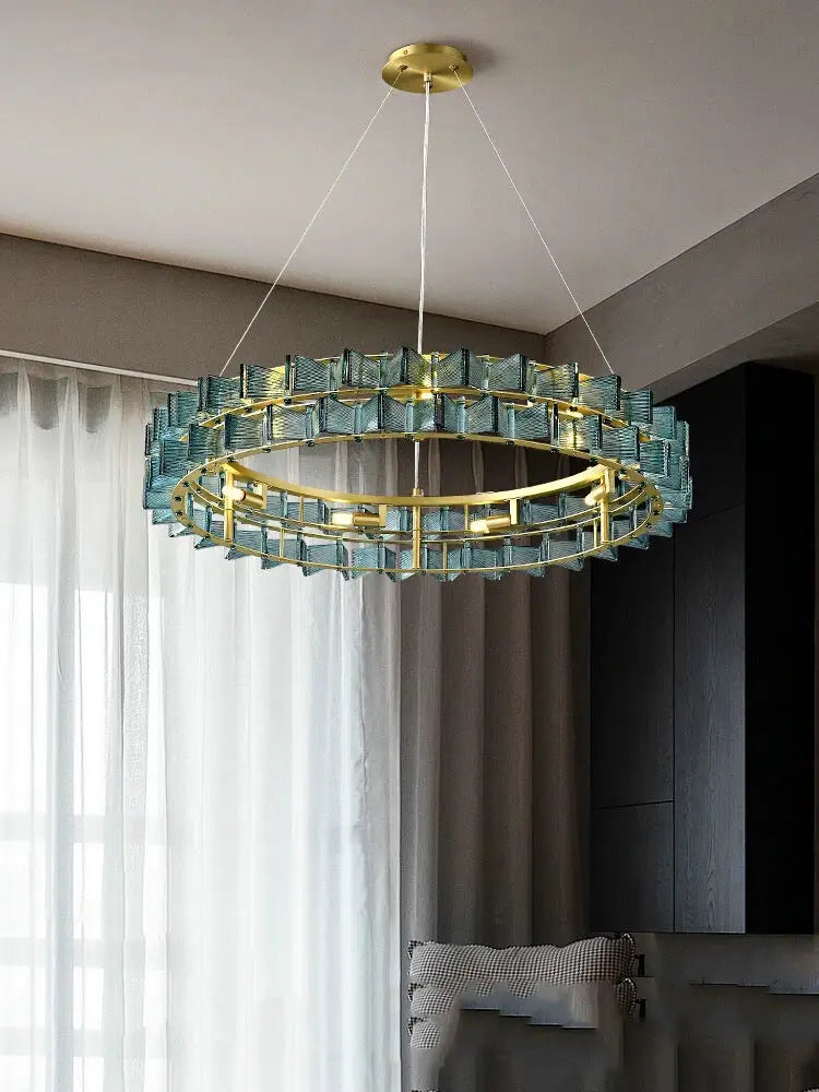 A decorbites butterfly glass chandelier with gold metal frame and teal glass segments for dining room lighting
