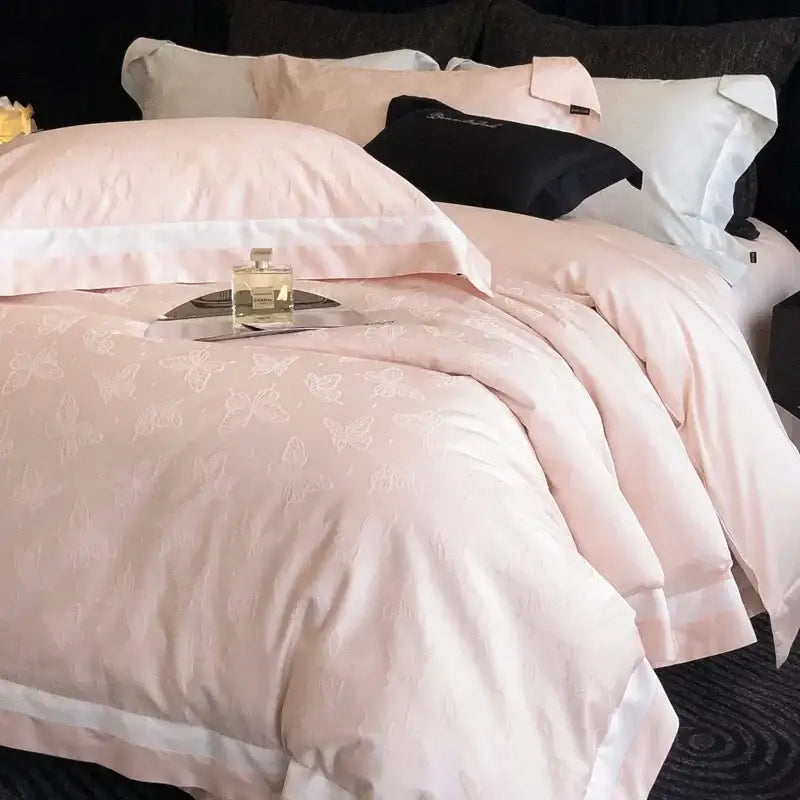 A soft pink satin duvet cover with white butterfly embroidery and matching pillowcases from decorbites butterfly jacquard bedding set