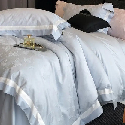 Light blue satin duvet cover with butterfly jacquard pattern and white piping from decorbites butterfly jacquard bedding set