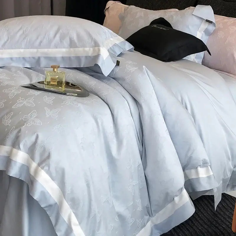 Light blue satin duvet cover with butterfly jacquard pattern and white piping from decorbites butterfly jacquard bedding set