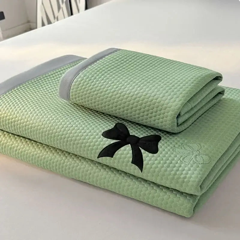 Light green cool mat bedroom cushion set with textured towel featuring black embroidered butterfly knot jacquard trim