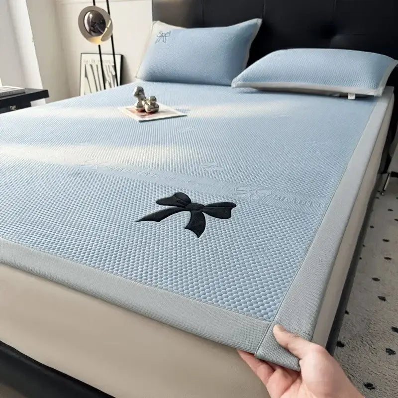 Light blue textured cooling mattress pad with black embroidered decorbites butterfly knot jacquard design for bedroom use