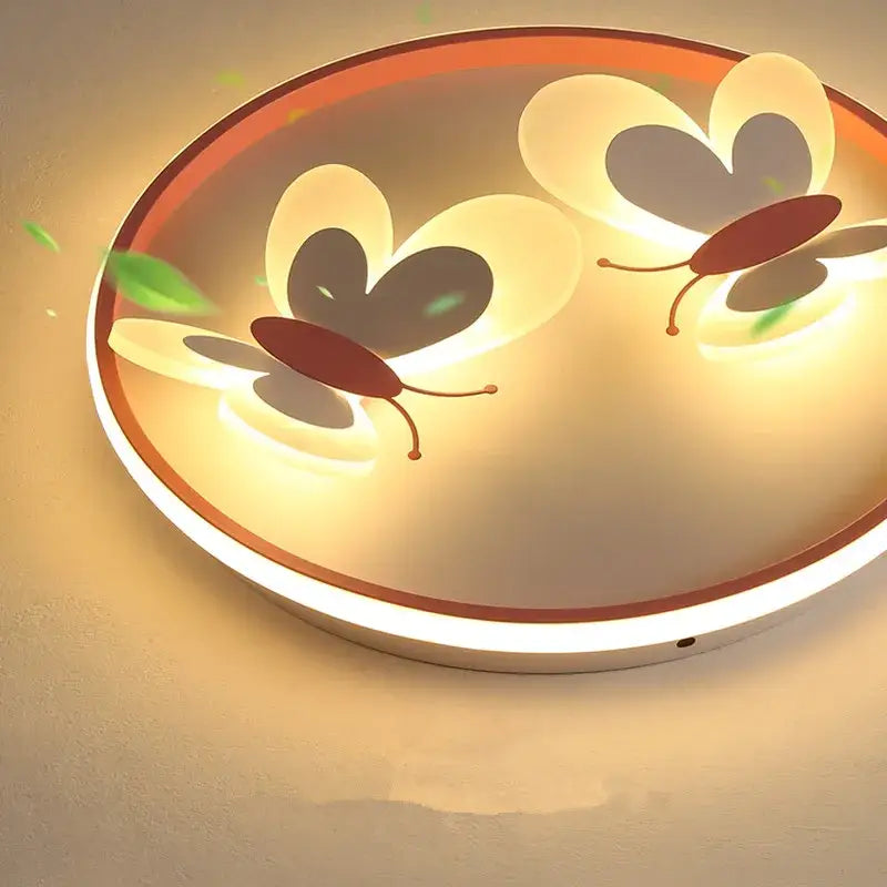 Butterfly pink ceiling light with illuminated butterfly designs in warm yellow glow and white maroon rim for kids room decorbites butterfly pink