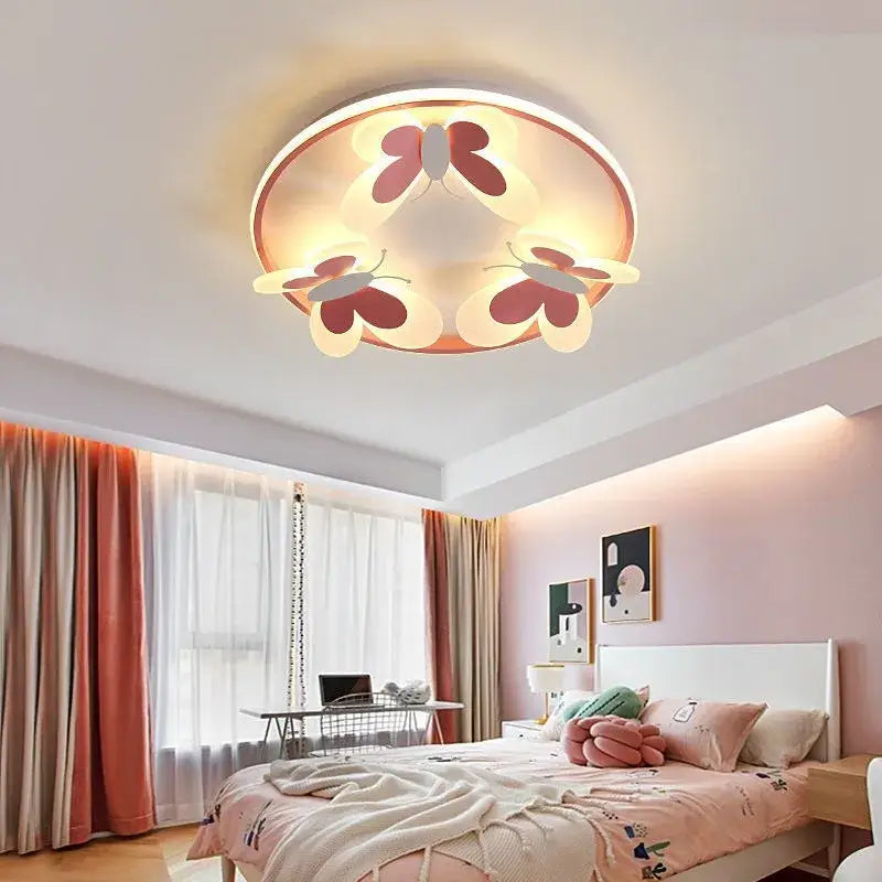 Round ceiling light with three pink and white butterfly designs illuminated by warm led lighting for kids room decorbites butterfly pink
