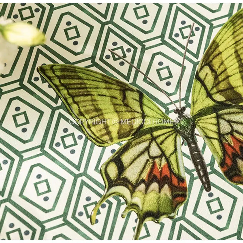 A butterfly print throw pillow featuring a vibrant green and orange butterfly on a green and off-white geometric decorbites design