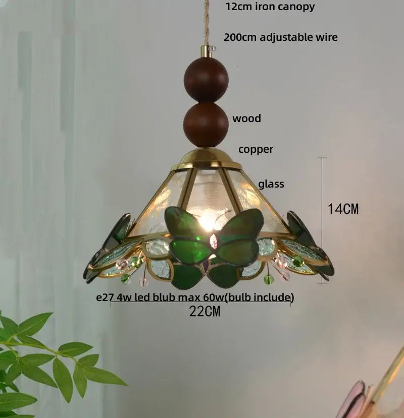 A decorbites butterfly tiffany glass pendant light with blue and green glass shade and copper accents for dining room decor