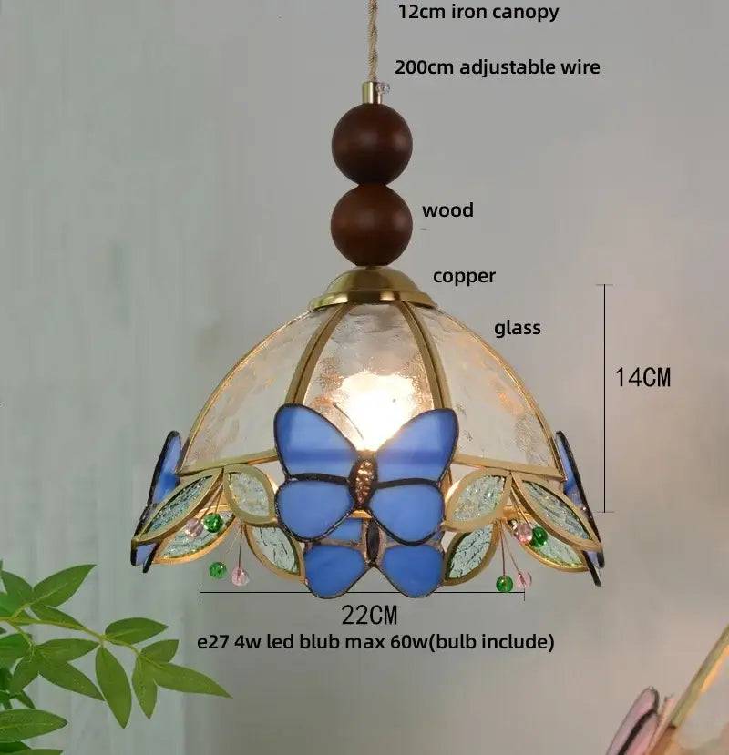 Delicate butterfly tiffany glass pendant lamp with blue and green shade, copper accents, and wooden beads for dining room decor