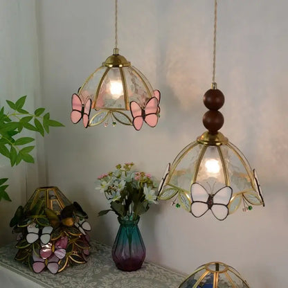 Two brass framed decorbites butterfly tiffany glass pendant lights with pink and white butterfly motifs for dining room