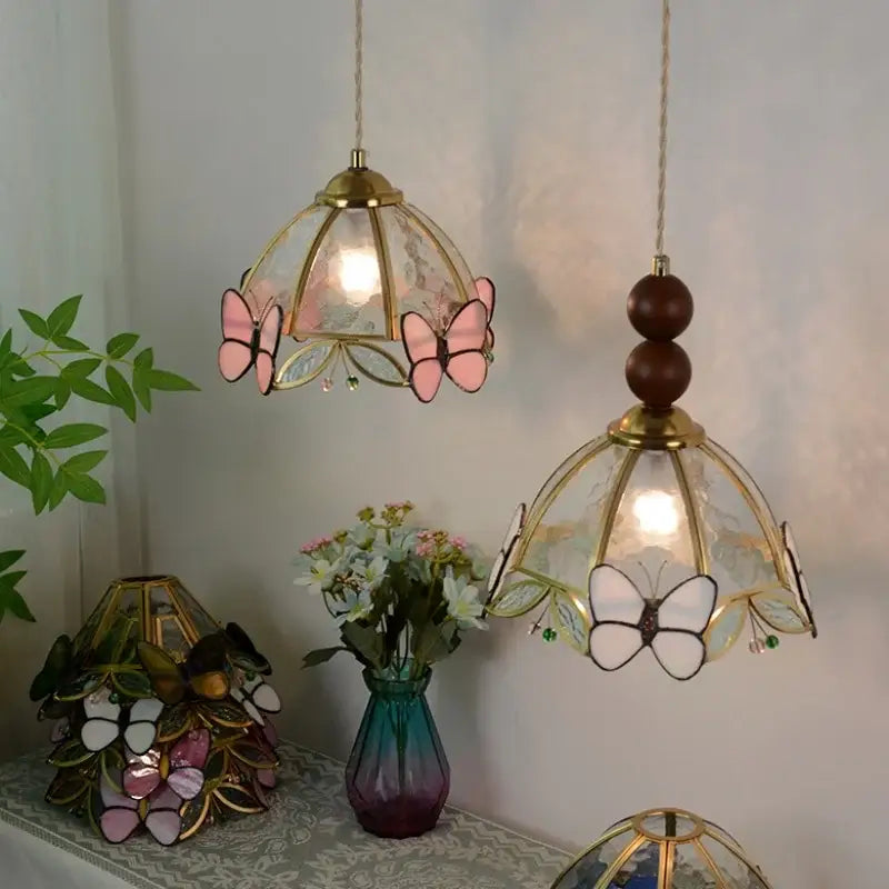 Two brass framed decorbites butterfly tiffany glass pendant lights with pink and white butterfly motifs for dining room