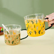 Clear glass tea milk cups with black handles featuring a playful cactus glass tea design and colorful beverages