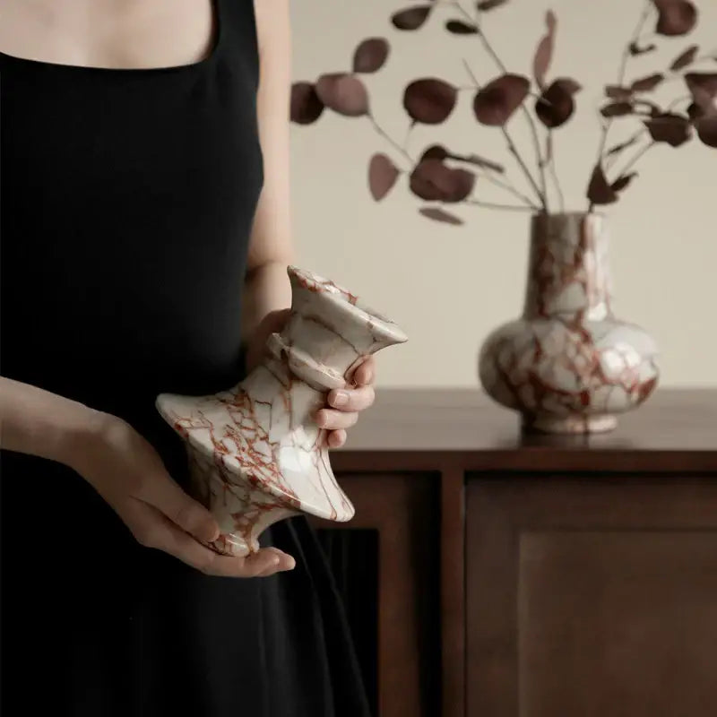 A handcrafted decorbites calacatta red marble vase with white rust marbled pattern and elegant flared neck for living room decor
