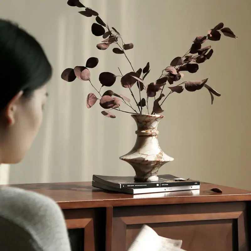 A rustic decorbites calacatta red marble vase with a fluted neck and bulbous body in red white and brown tones