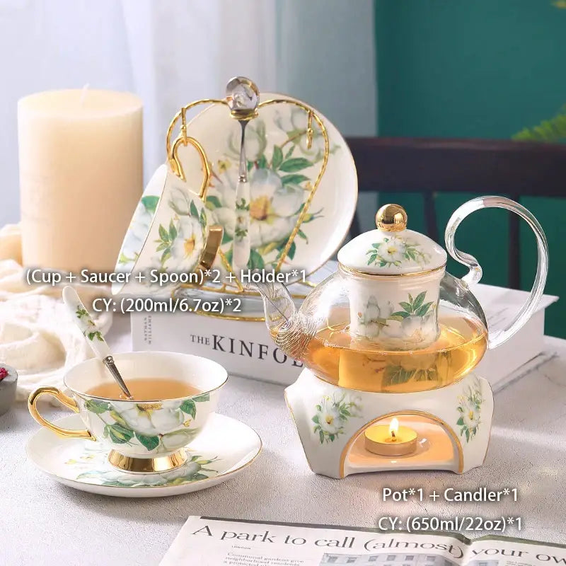 Glass teapot with white floral design and gold trim on ceramic base with candle for decorbites camellia floral tea set