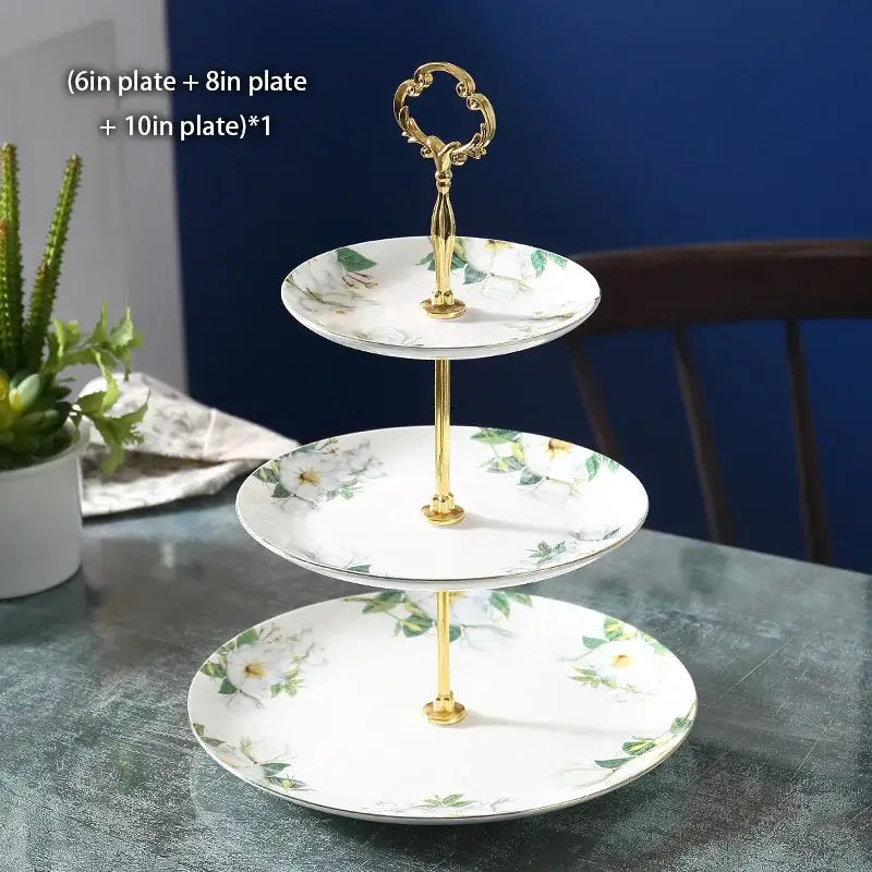 Three-tiered tea set with white porcelain plates, delicate camellia floral patterns, and gold-toned ornate handles by decorbites camellia floral