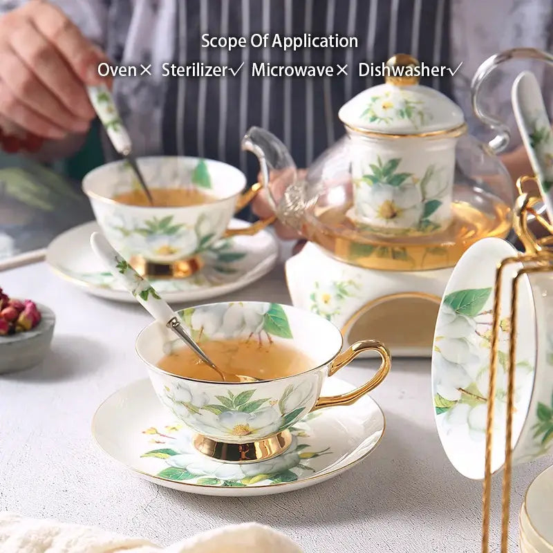 Elegant white porcelain teacup with gold trim and delicate floral design filled with tea from decorbites camellia floral tea set