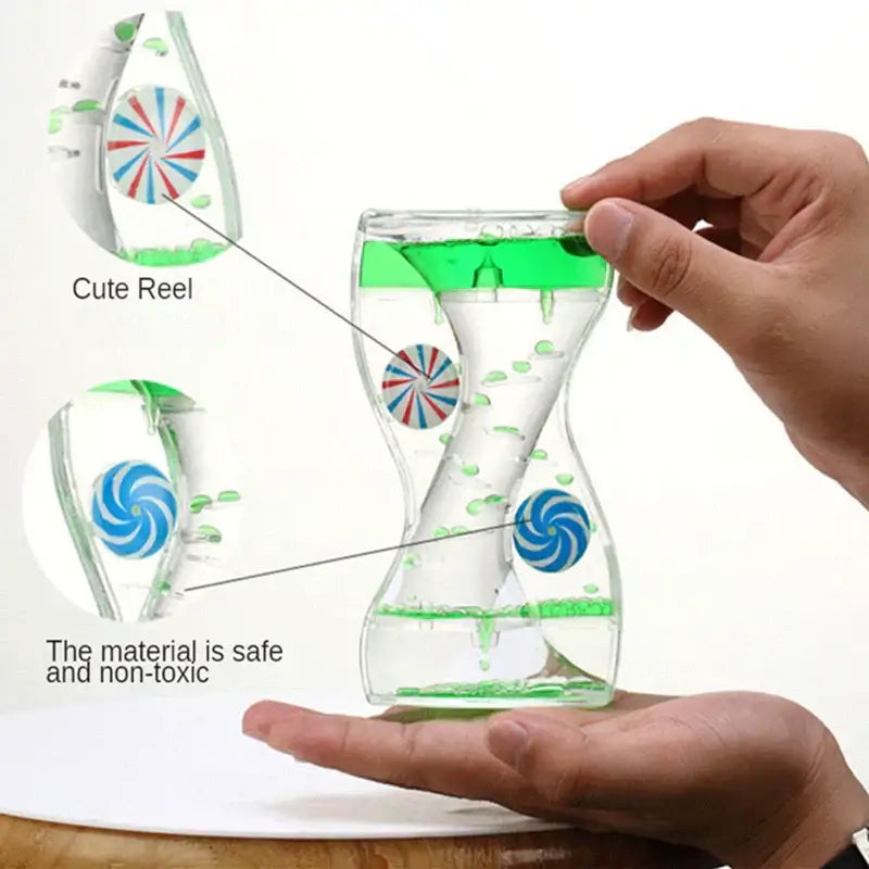 Clear glass liquid motion sand timer with green swirling fluid and colorful spiral reels for blue and green decor