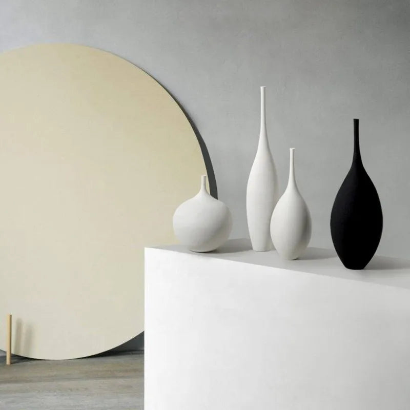 Set of minimalist white and black CAPIRON zen ceramic vases with sleek elongated forms for home decoration
