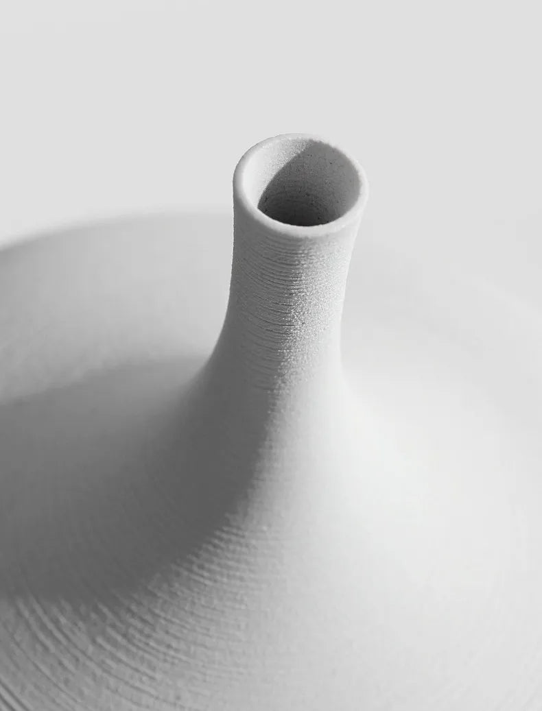 A minimalist white ceramic CAPIRON zen vase with slender neck and textured ridges for nordic home decoration