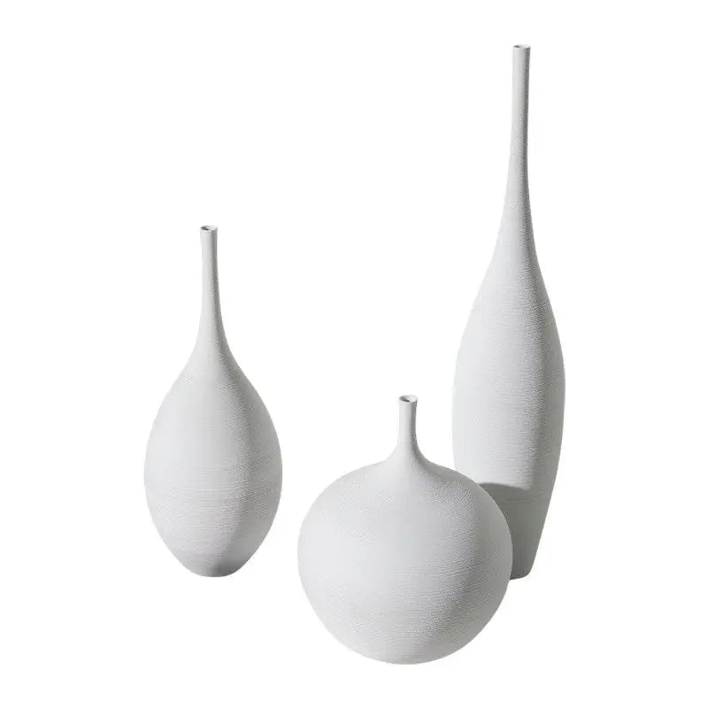 Set of three white ceramic vases with textured surfaces and slender necks for nordic home decoration by capiron
