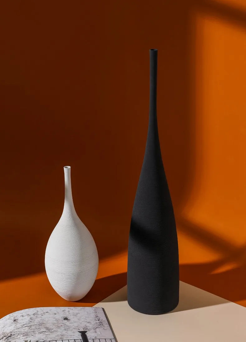Black matte ceramic zen vase with slender neck and tapered base for nordic living room decoration and centerpiece
