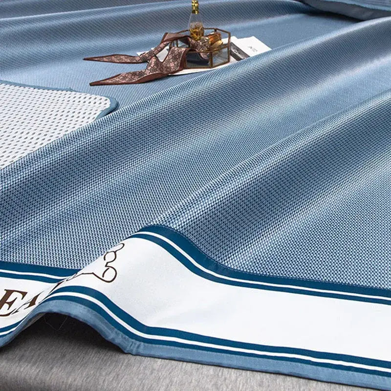 Light blue decorbites carbon light cooling mat with white border navy stripes and brown script lettering for bedroom use