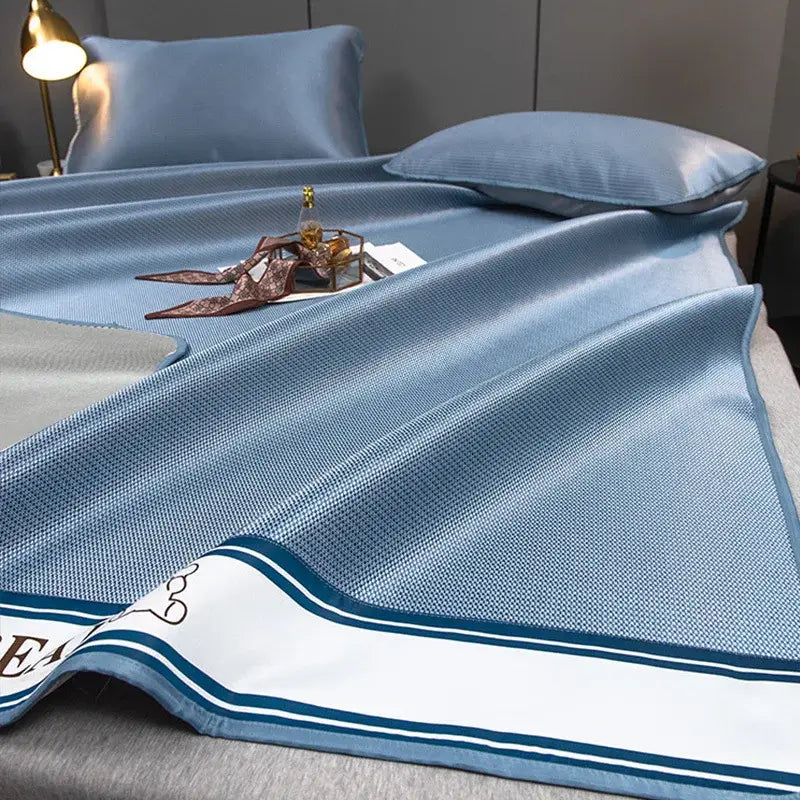 Light blue decorbites carbon light cooling mat and pillowcase set with textured weave and navy striped border