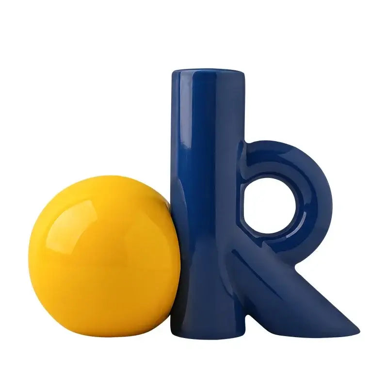 Vibrant yellow glossy sphere beside sleek navy blue ceramic letter k in decorbites cartoon abstract ceramic vase decor