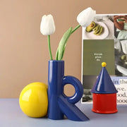 Blue abstract ceramic vase shaped like letter k holding white tulips for decorbites cartoon abstract living room decor