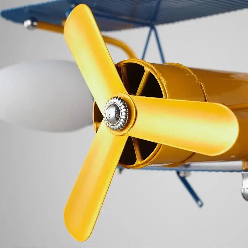 Yellow metal propeller with silver hub on vintage biplane lamp for decorbites cartoon aircraft ceiling bedroom fan