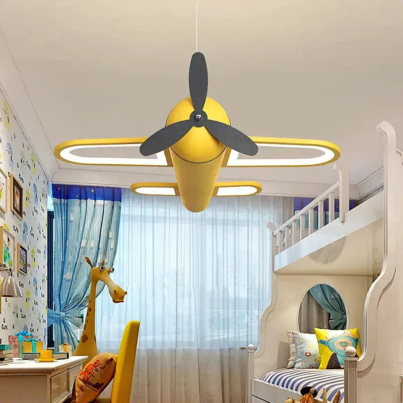 Yellow pendant light shaped like airplane with black propeller and illuminated wings for decorbites cartoon airplane kids bedroom