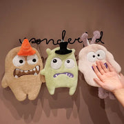 Three cartoon animal coral velvet monster hand towels in tan green and pink with embroidered faces and hats for kitchen decor