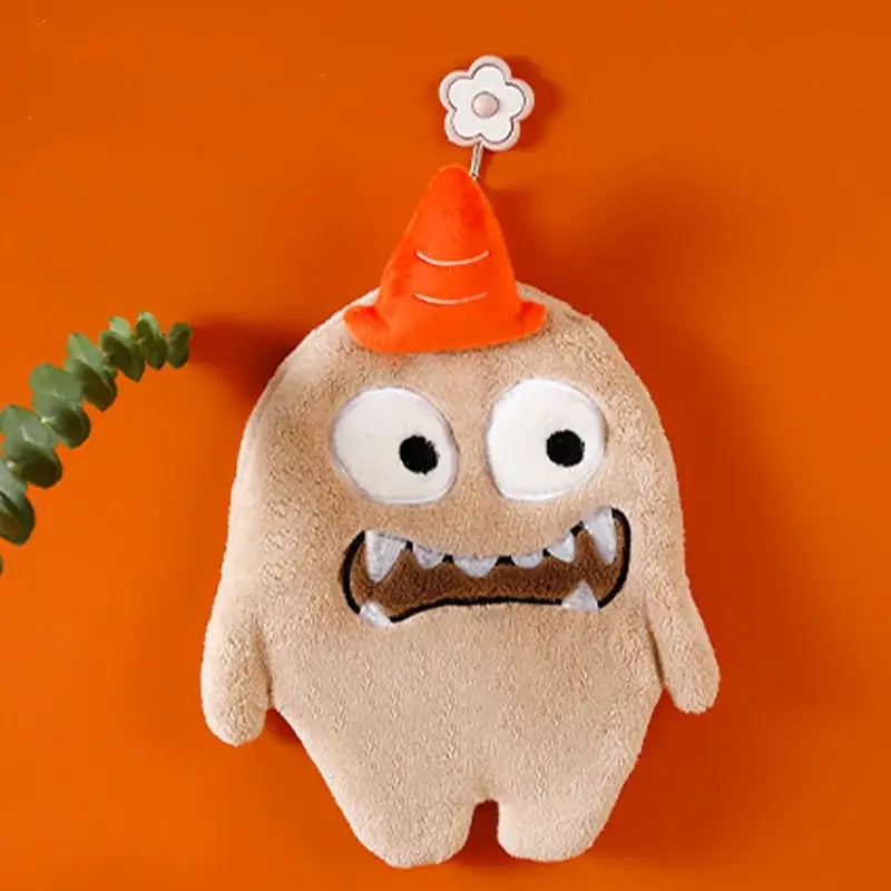 Beige plush cartoon animal hand towel made of coral velvet with large eyes and orange cone hat for kitchen decor