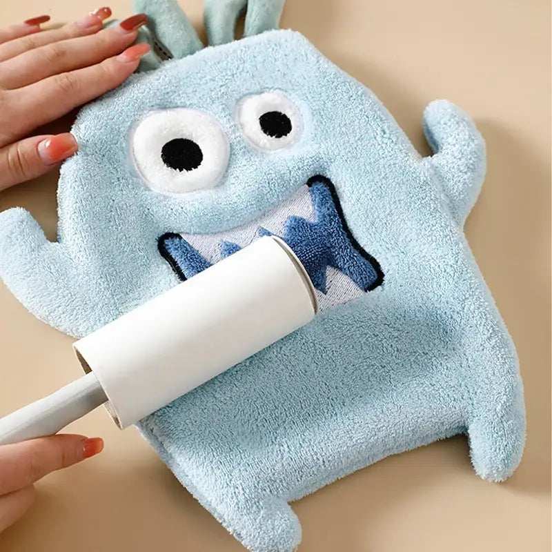 Light blue coral velvet cartoon animal hand towel shaped like a plush monster with embroidered eyes and smiling mouth