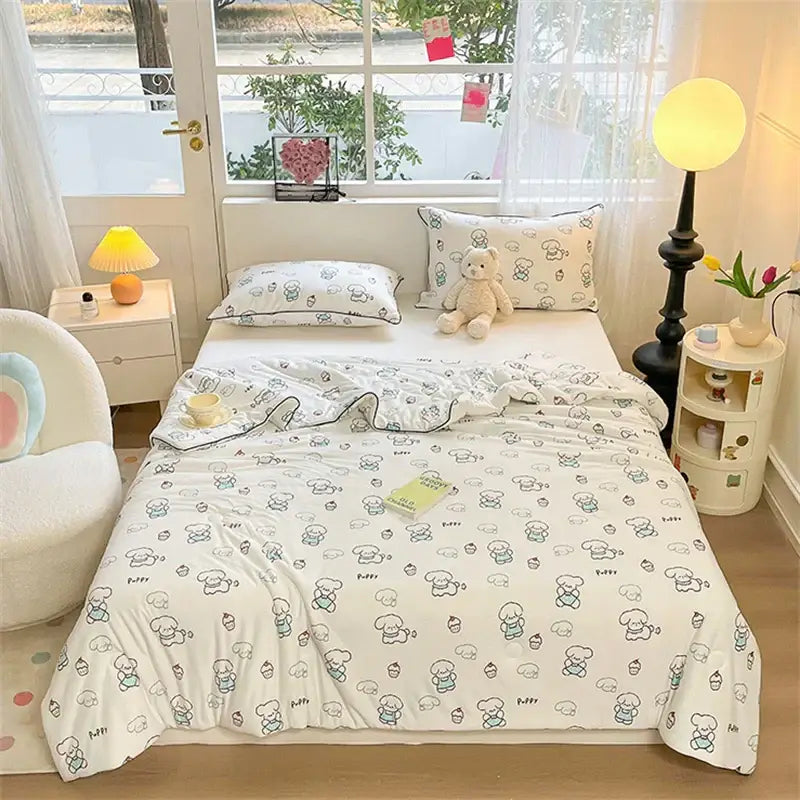 White kids summer quilt with cartoon dogs and cupcakes pattern in soft blue green and gray tones by decorbites kids