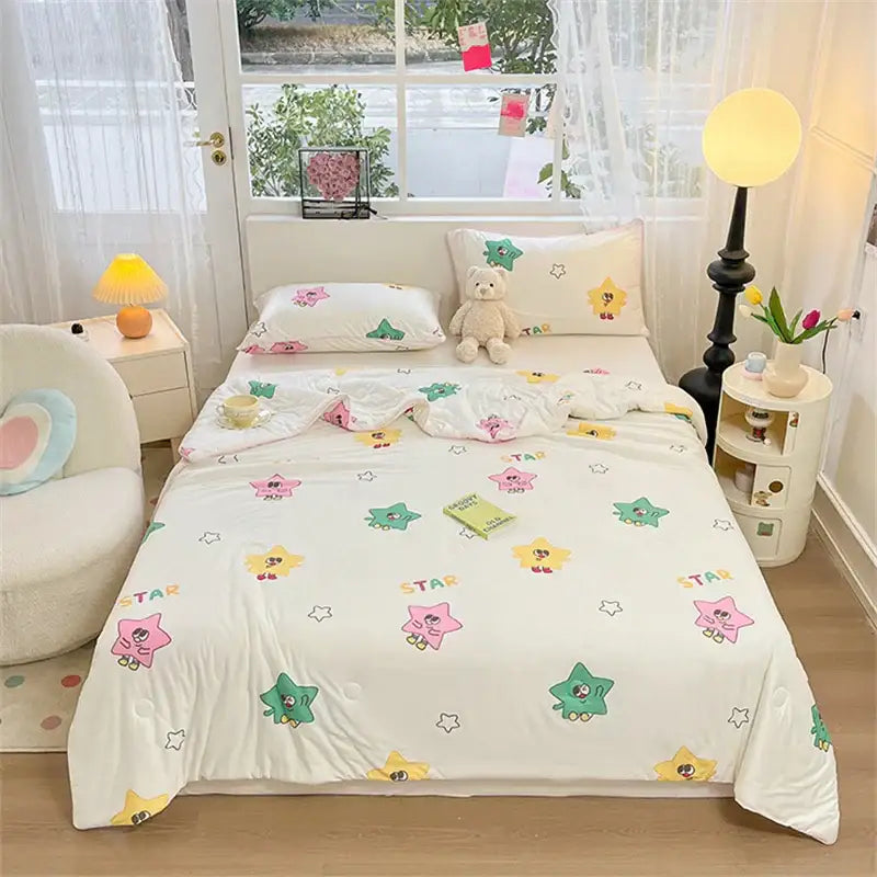 White quilted kids summer quilt with colorful cartoon star print in pink green and yellow soft knitted comforter by decorbites kids