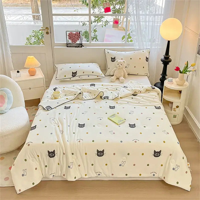 Cream-colored kids summer quilt with black and gray cartoon cats gold polka dots soft cotton fabric by decorbites kids