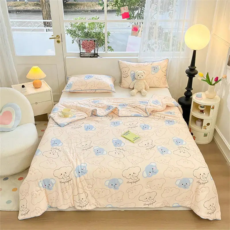 Cream-colored kids summer quilt by decorbites featuring a playful light blue and beige cartoon bear pattern